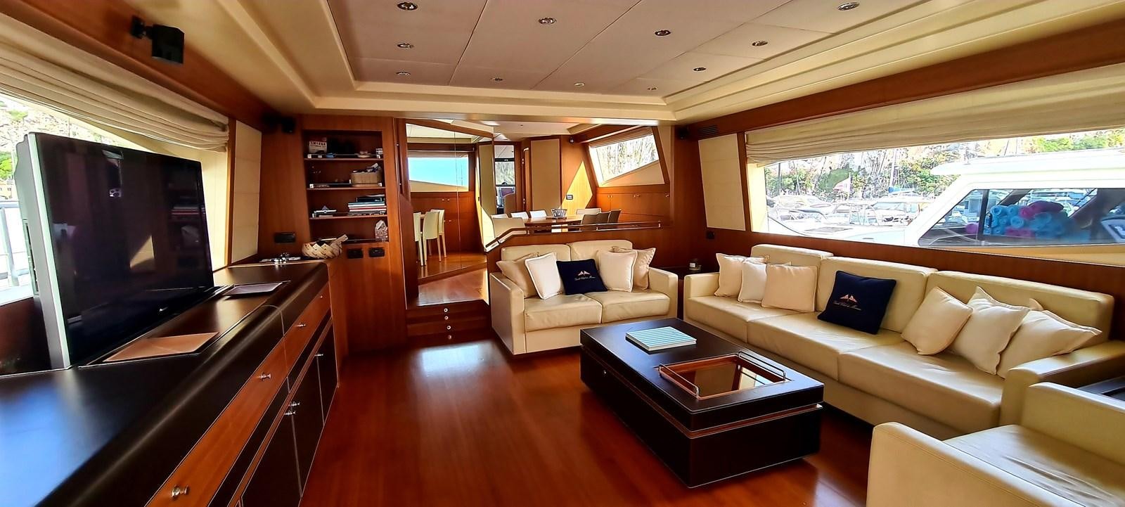 a living room with a couch and a television aboard RITAKI 7 Yacht for Sale