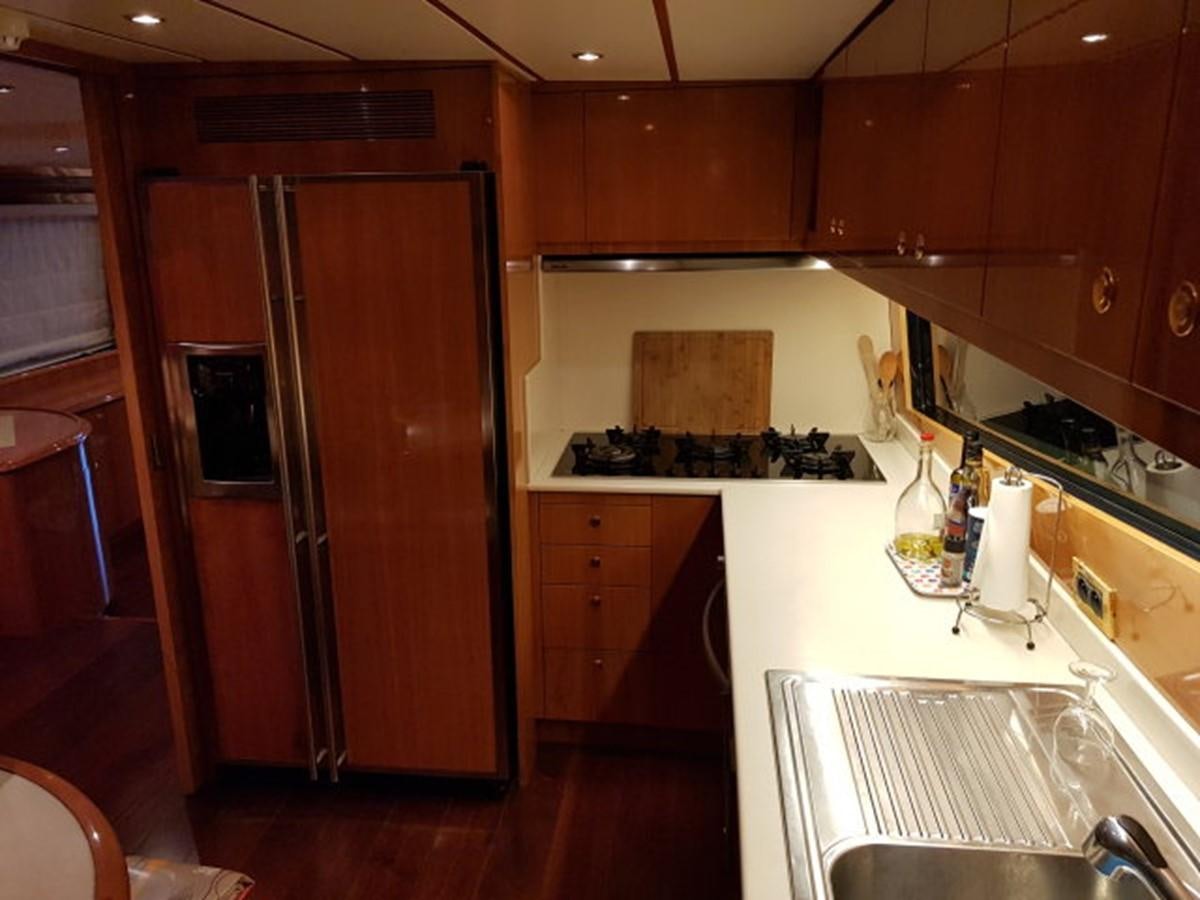 a kitchen with wooden cabinets aboard BLUE DEEP Yacht for Sale