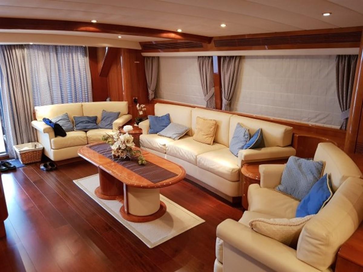 a living room with a table and couches aboard BLUE DEEP Yacht for Sale