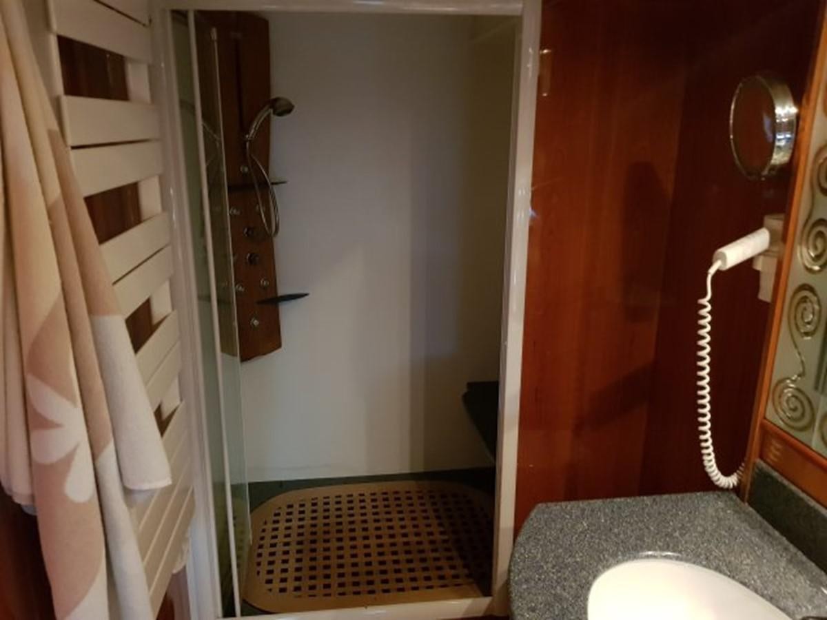 a bathroom with a shower curtain aboard BLUE DEEP Yacht for Sale
