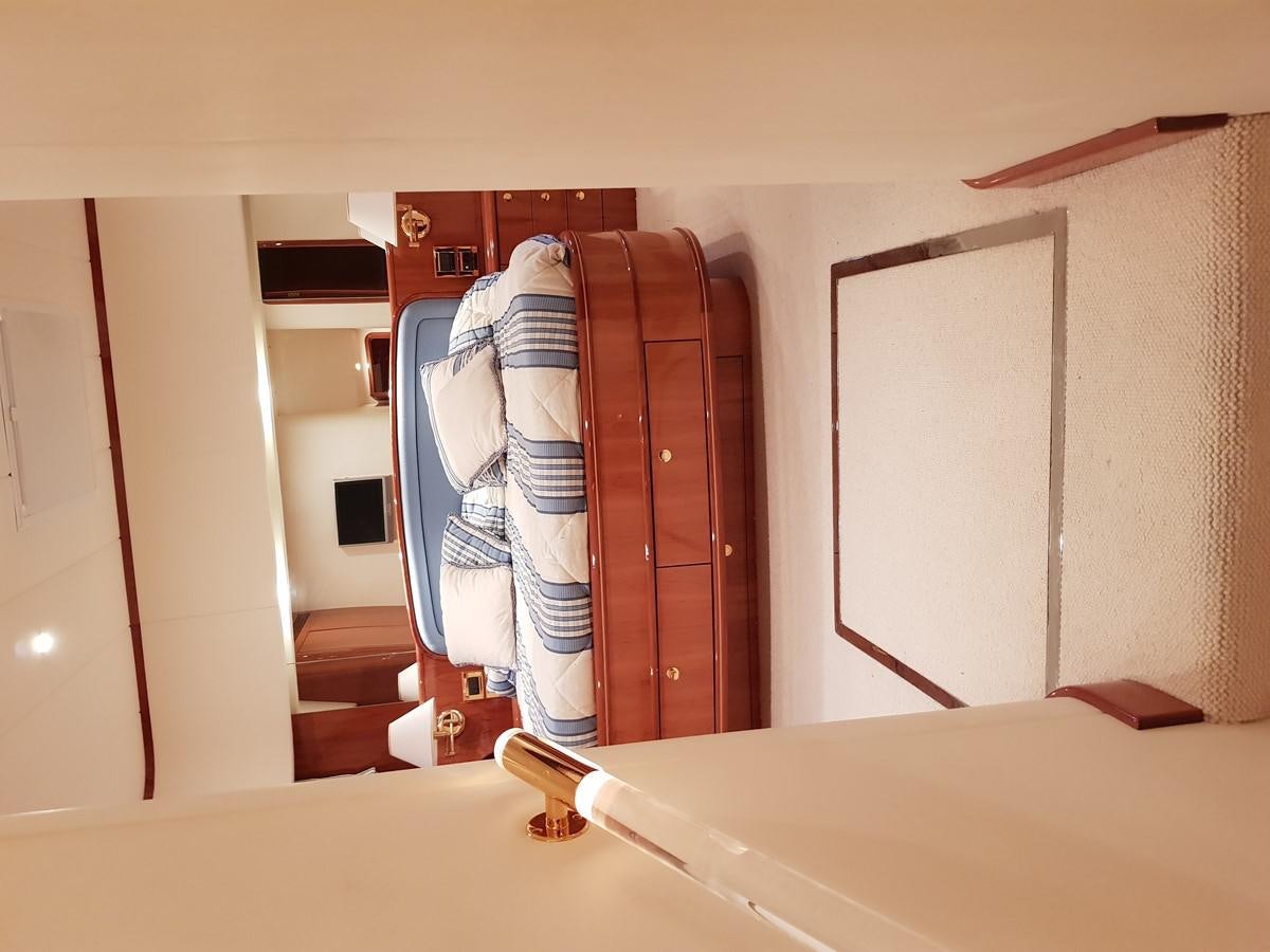 a room with a bed and a closet aboard BLUE DEEP Yacht for Sale