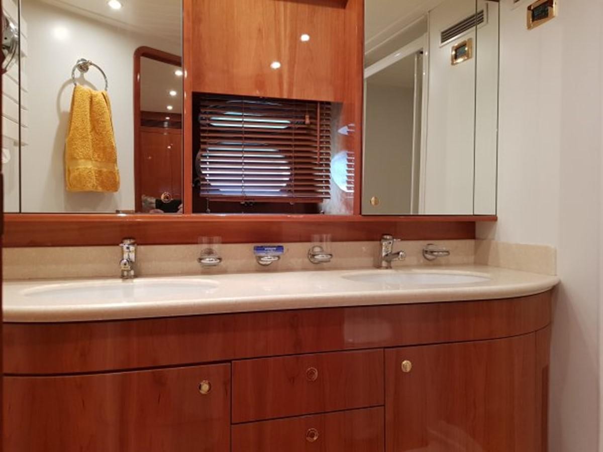 a bathroom with a sink and a mirror aboard BLUE DEEP Yacht for Sale