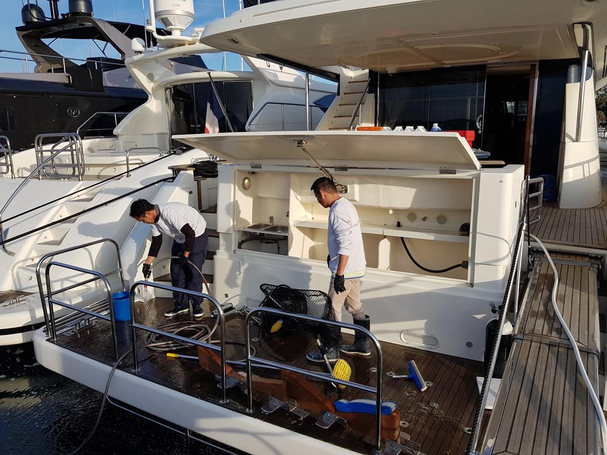 several men working on a machine aboard BLUE DEEP Yacht for Sale