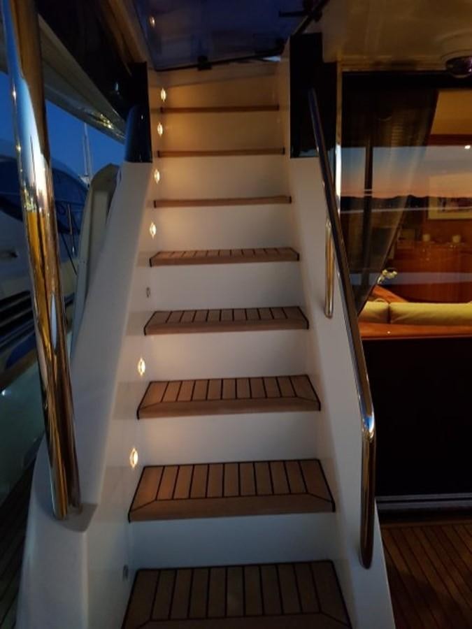 a staircase with glass doors aboard BLUE DEEP Yacht for Sale