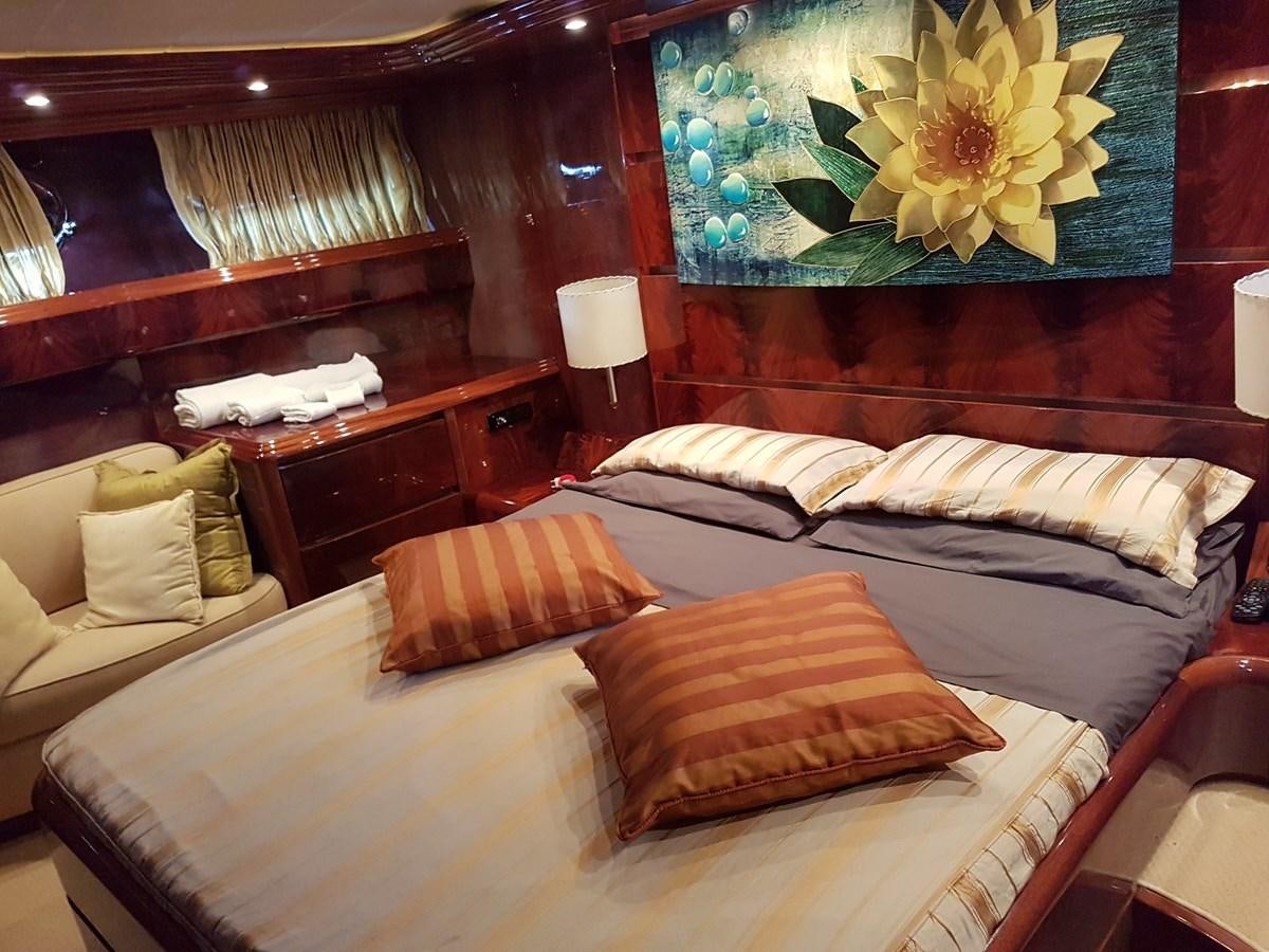 a bed with a painting on the wall aboard GEMINI 3 Yacht for Sale