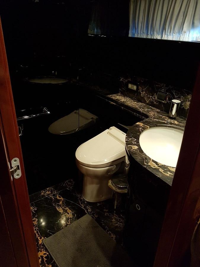 a bathroom with a toilet and a sink aboard GEMINI 3 Yacht for Sale