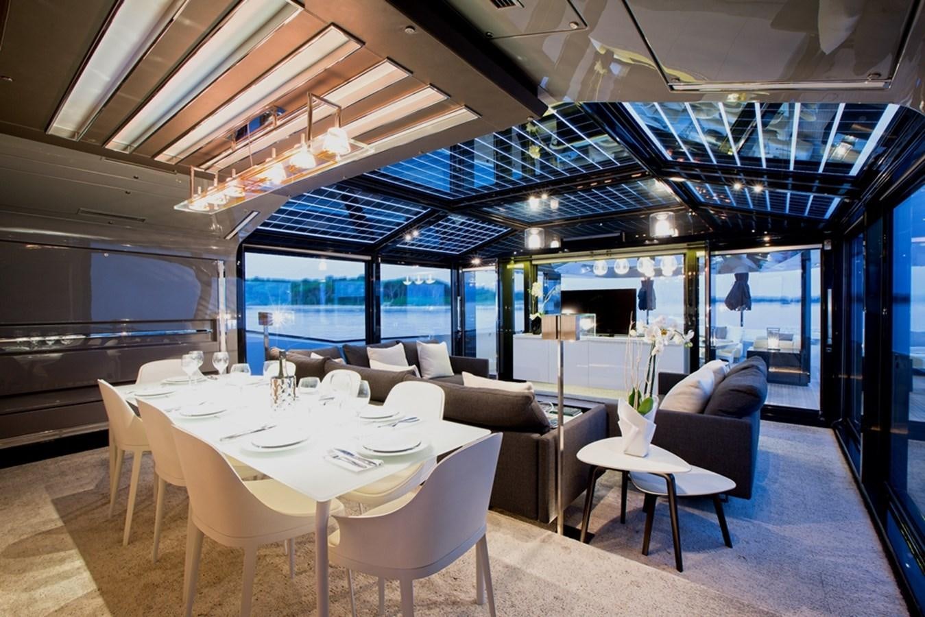 a room with tables and chairs aboard PANGEA Yacht for Sale