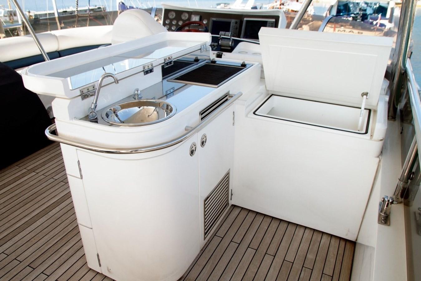 a white kitchen with a sink aboard PRINCESS 25 M Yacht for Sale