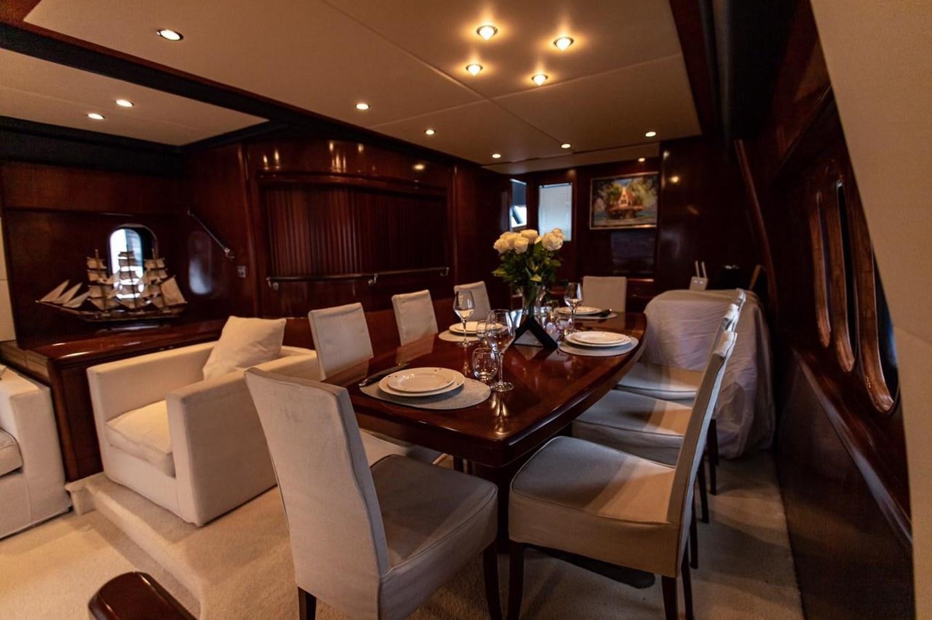 a dining table with chairs and a large mirror aboard PRINCESS 25 M Yacht for Sale