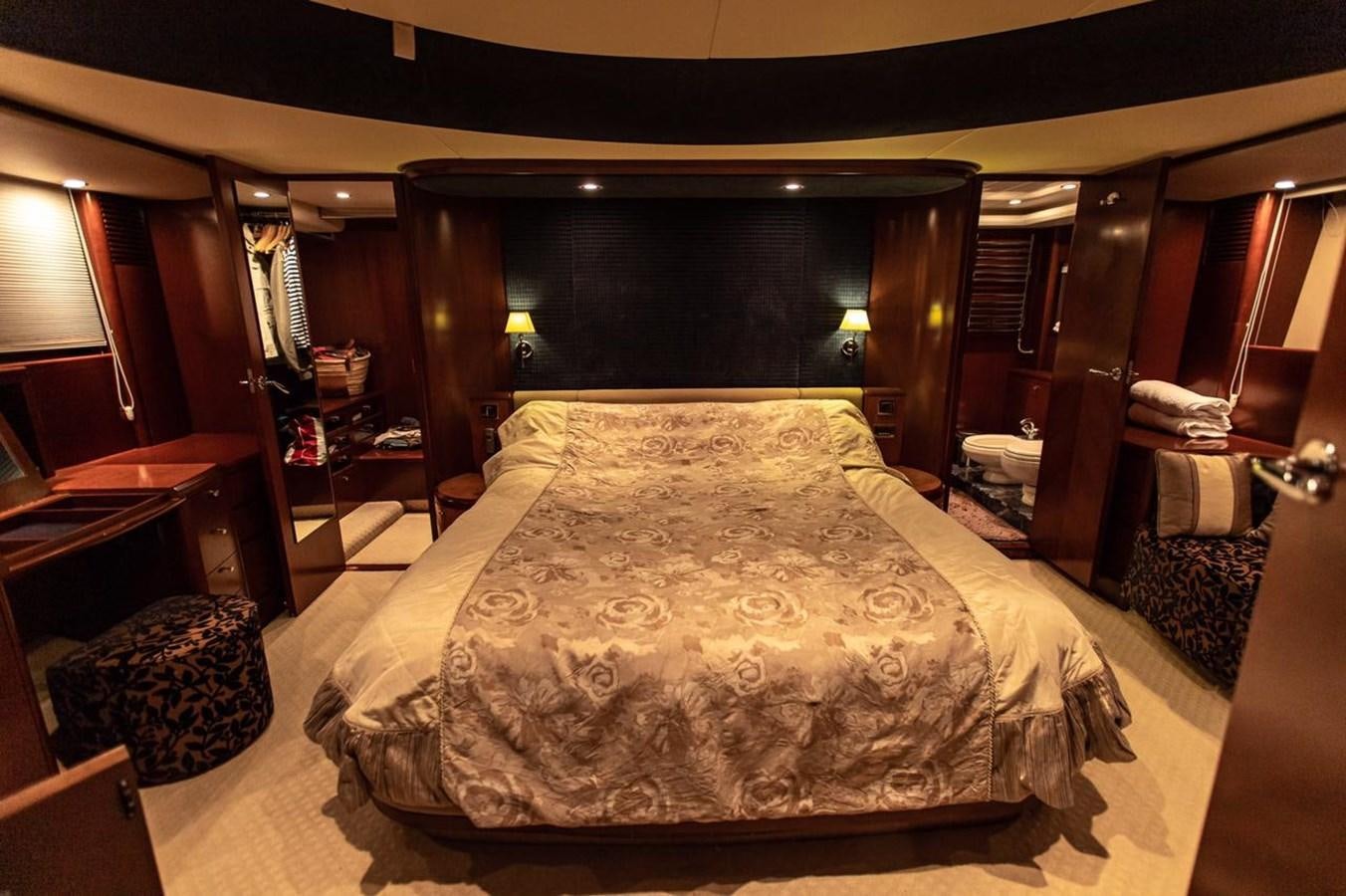 a bed with a white comforter aboard PRINCESS 25 M Yacht for Sale