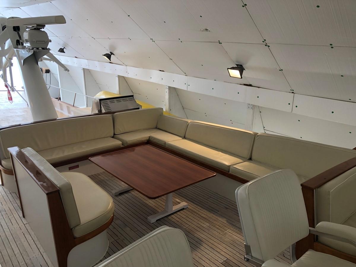 a room with chairs and a table aboard GOLDEN EAGLE Yacht for Sale