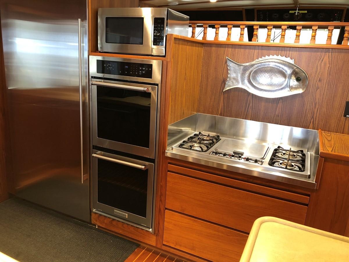 a kitchen with wooden cabinets aboard GOLDEN EAGLE Yacht for Sale