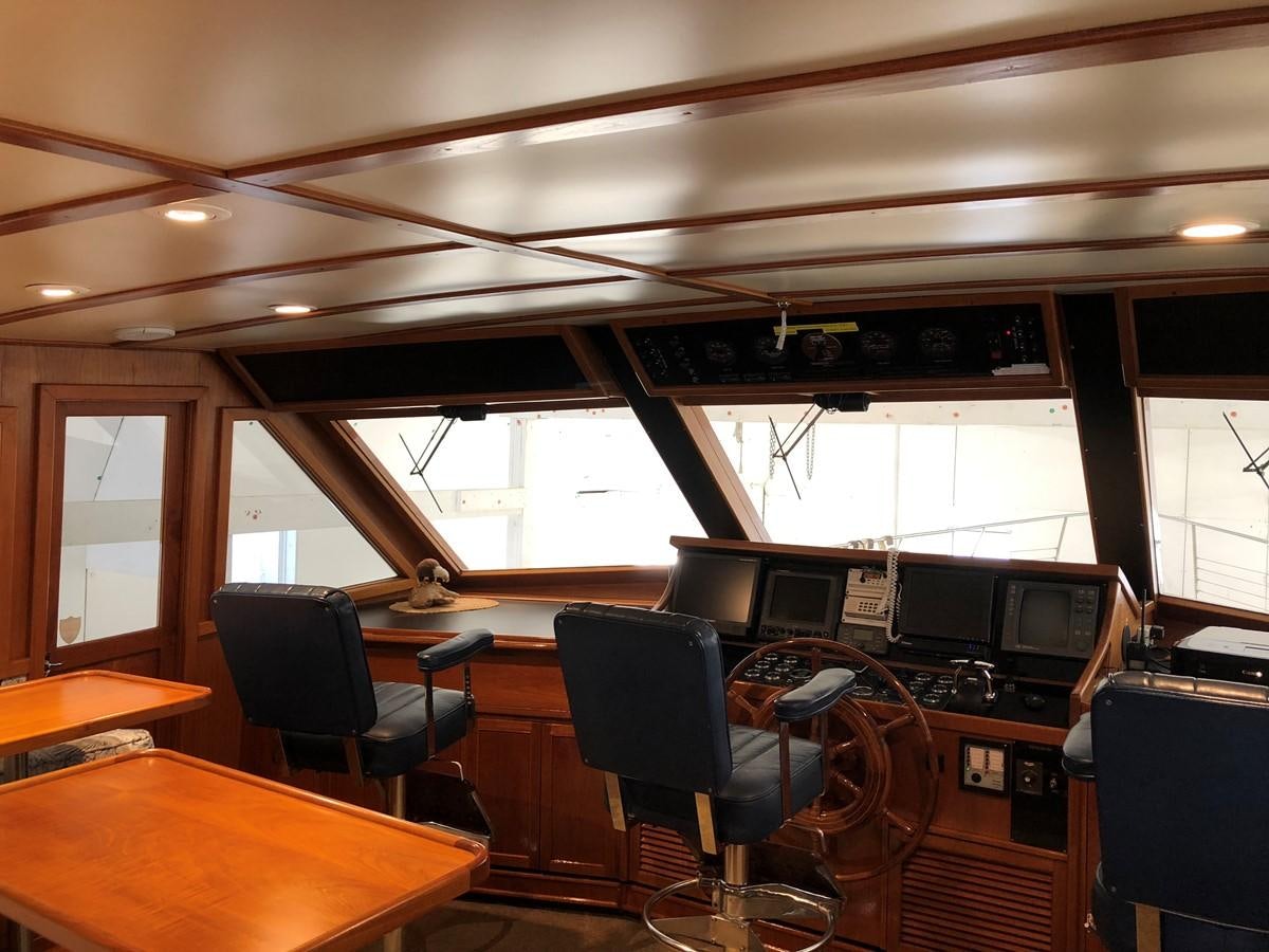 a room with a table and chairs aboard GOLDEN EAGLE Yacht for Sale
