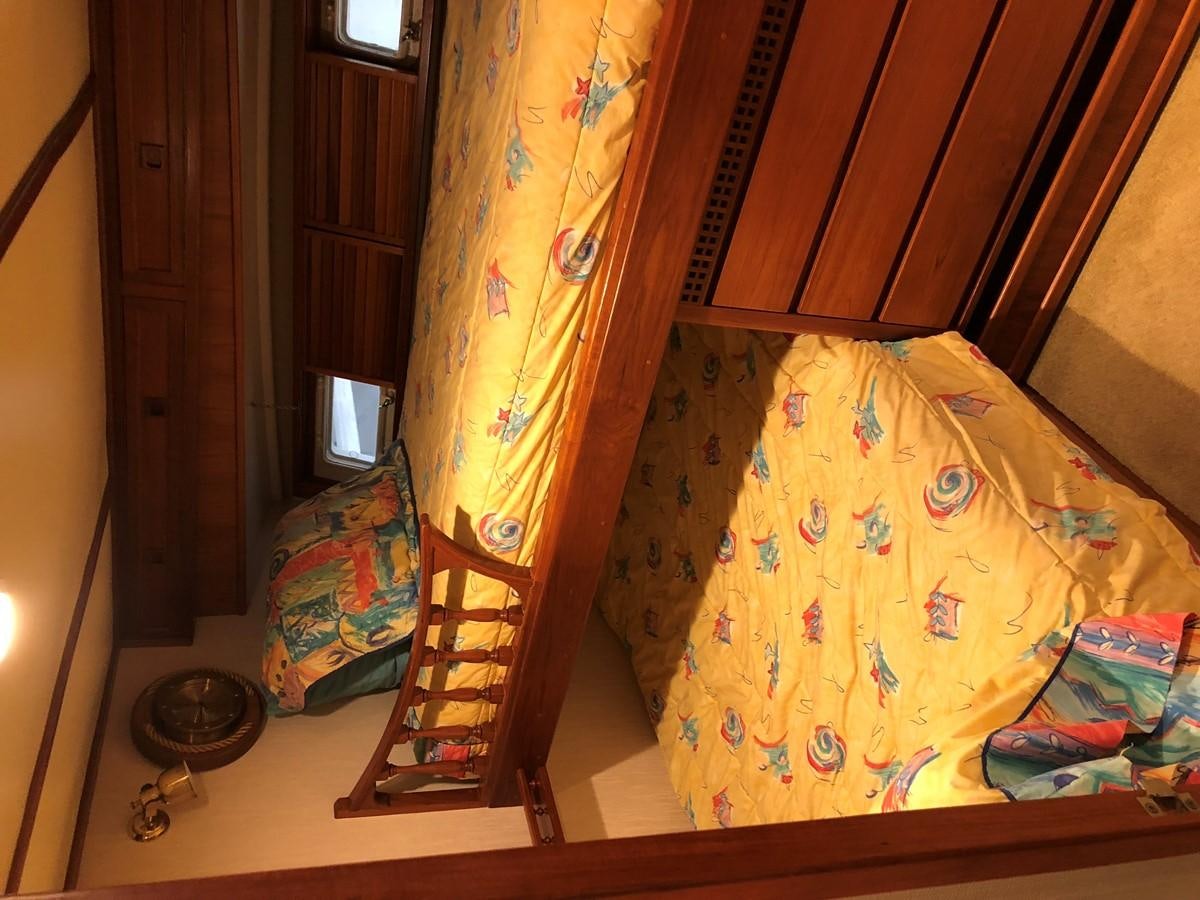 a bed with a yellow sheet aboard GOLDEN EAGLE Yacht for Sale