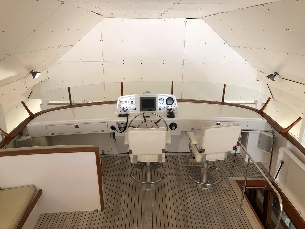 a white space ship with chairs and tables aboard GOLDEN EAGLE Yacht for Sale