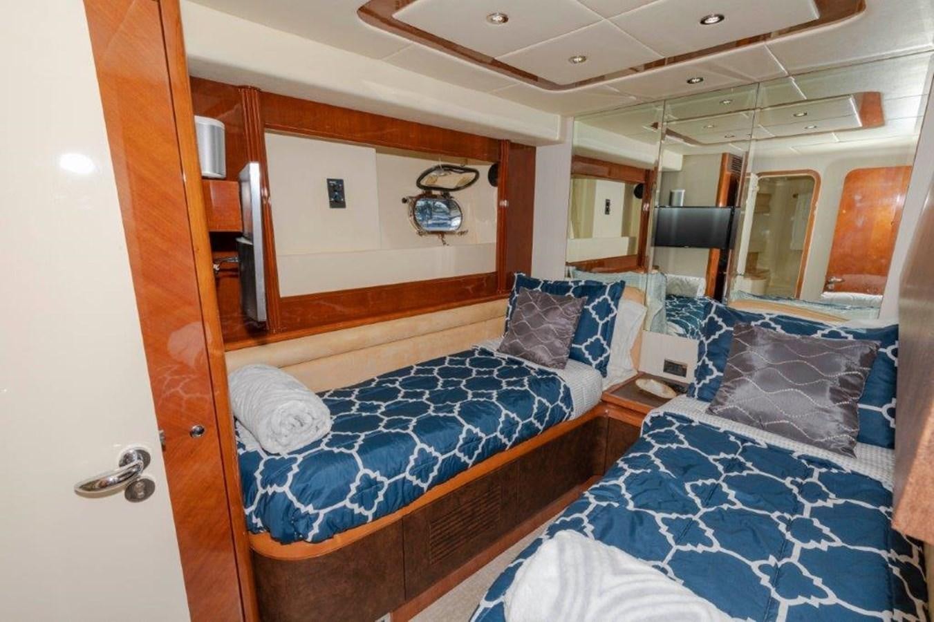 a bedroom with a bed and a mirror aboard DAY DREAMIN' Yacht for Sale