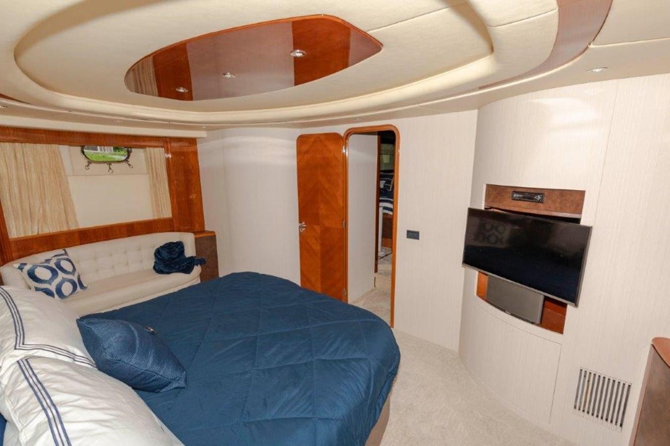 a room with a bed and a television aboard DAY DREAMIN' Yacht for Sale