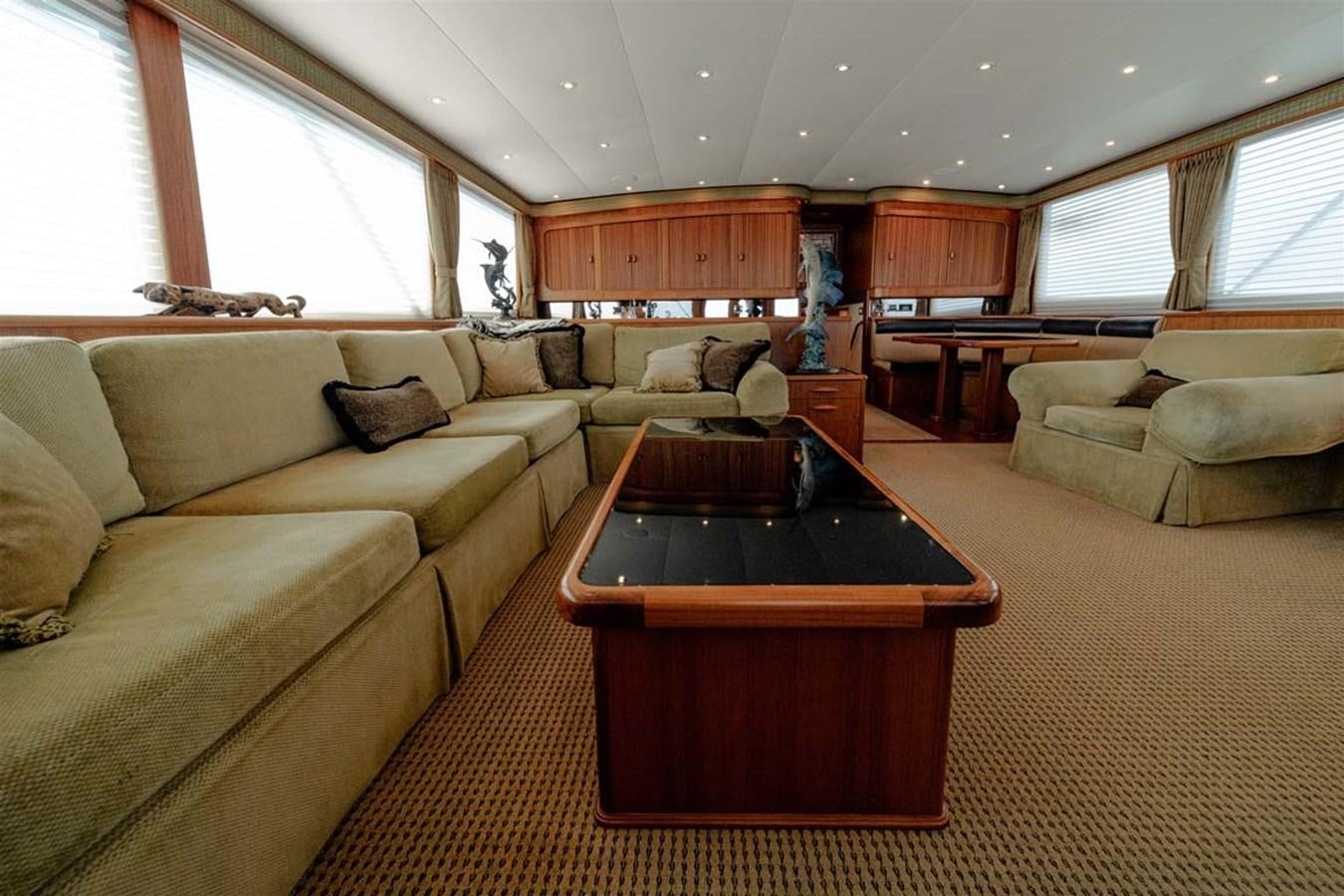 a living room with a table and couches aboard SILKY Yacht for Sale