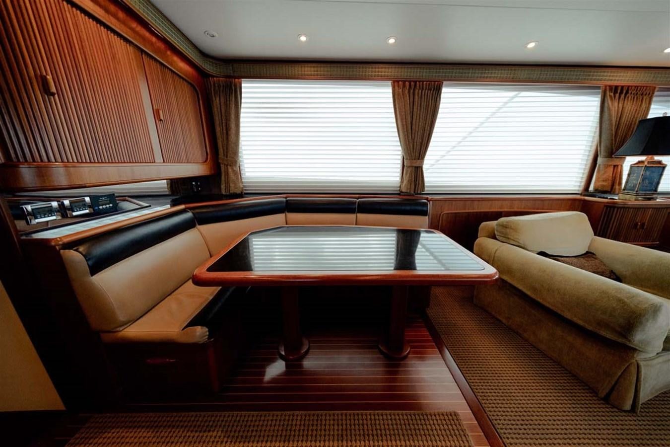 a room with a table and couch aboard SILKY Yacht for Sale