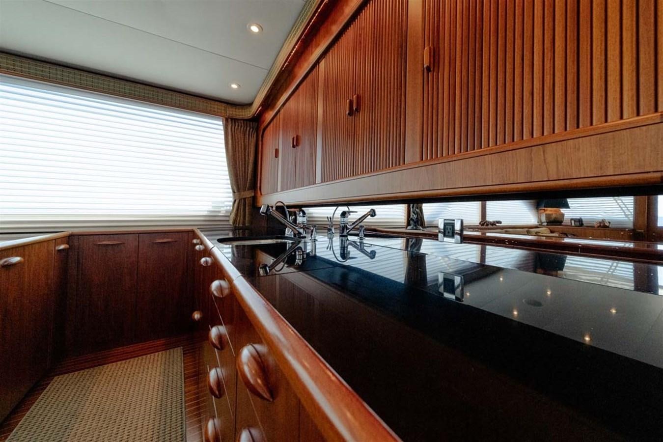 a kitchen with wooden cabinets aboard SILKY Yacht for Sale