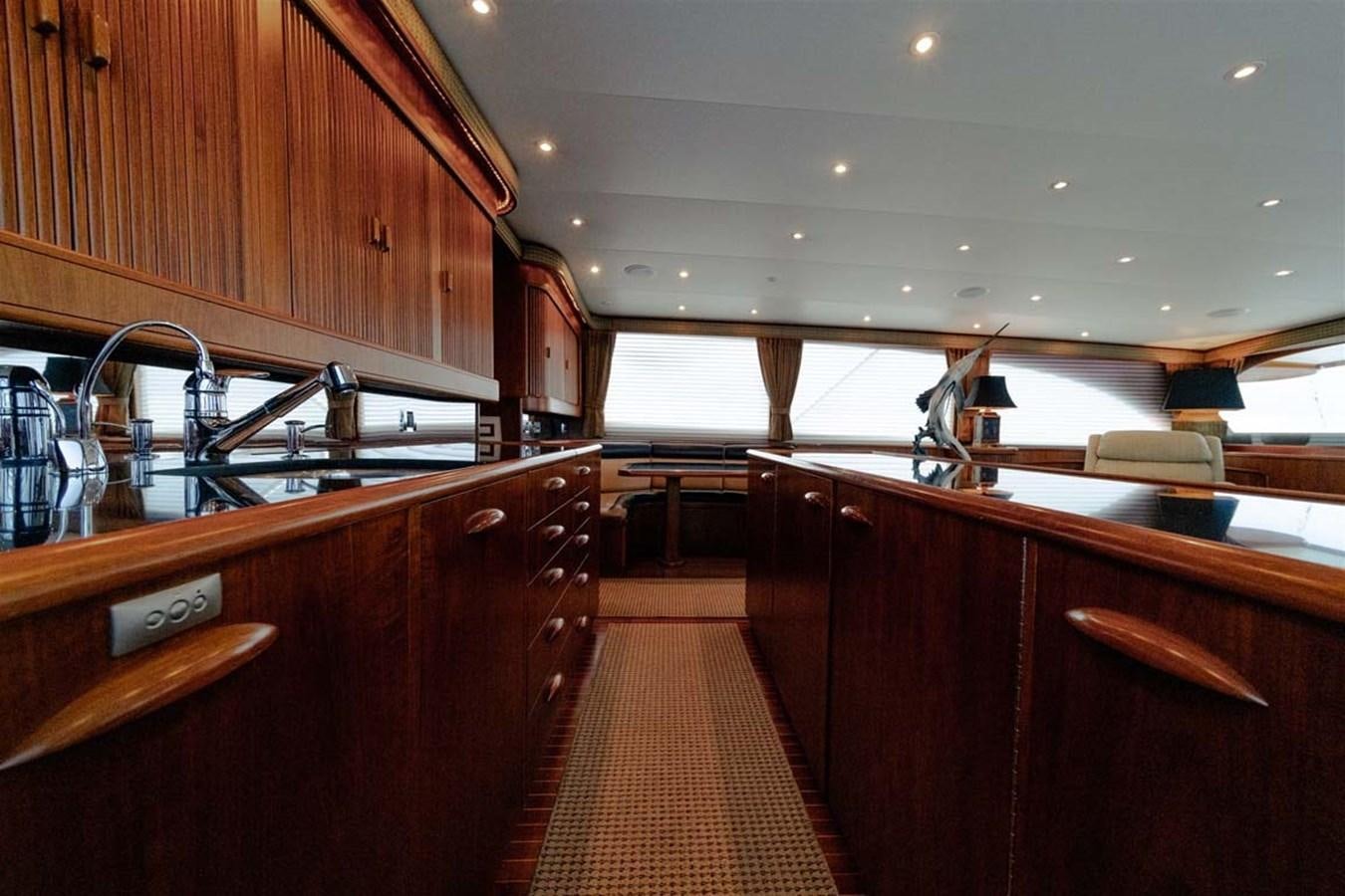a kitchen with wooden cabinets aboard SILKY Yacht for Sale