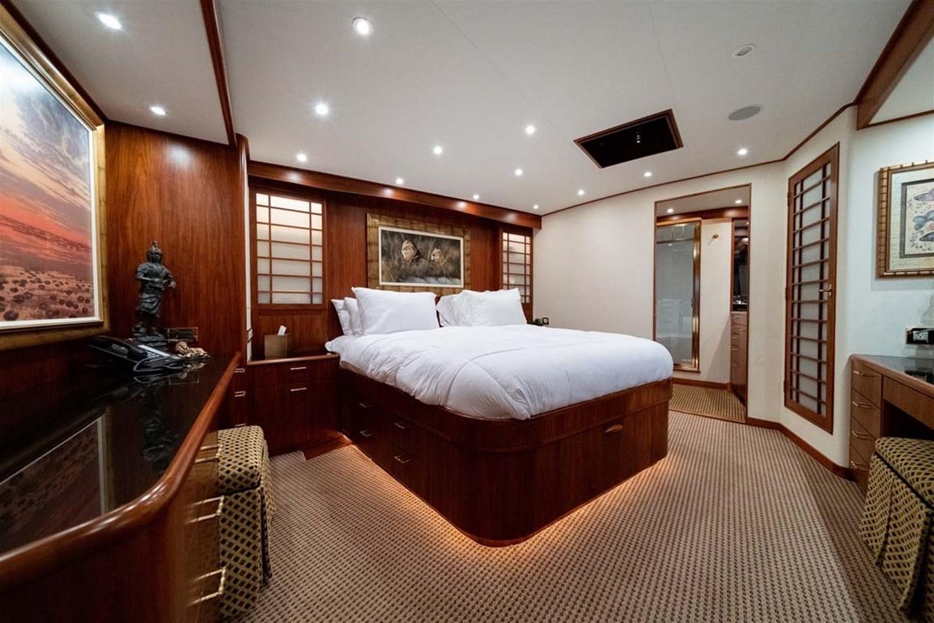 a bedroom with a bed and a dresser aboard SILKY Yacht for Sale