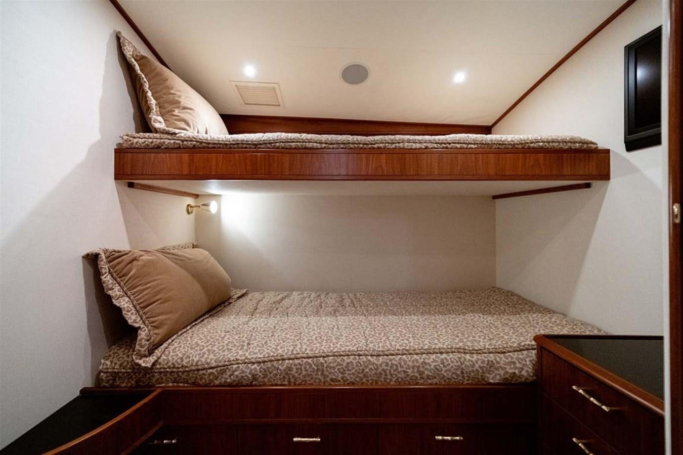 a bed with a wooden headboard aboard SILKY Yacht for Sale