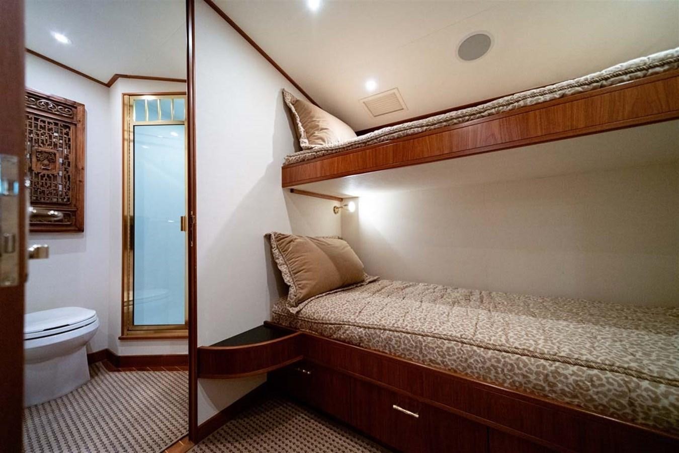 a bedroom with a bed and a mirror aboard SILKY Yacht for Sale
