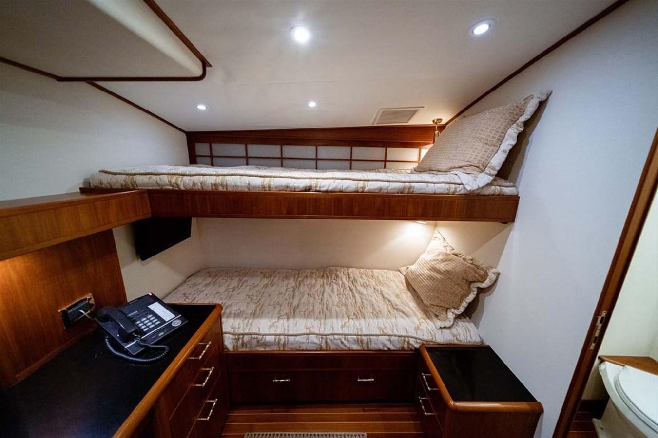 a bed with a desk and a computer on it aboard SILKY Yacht for Sale