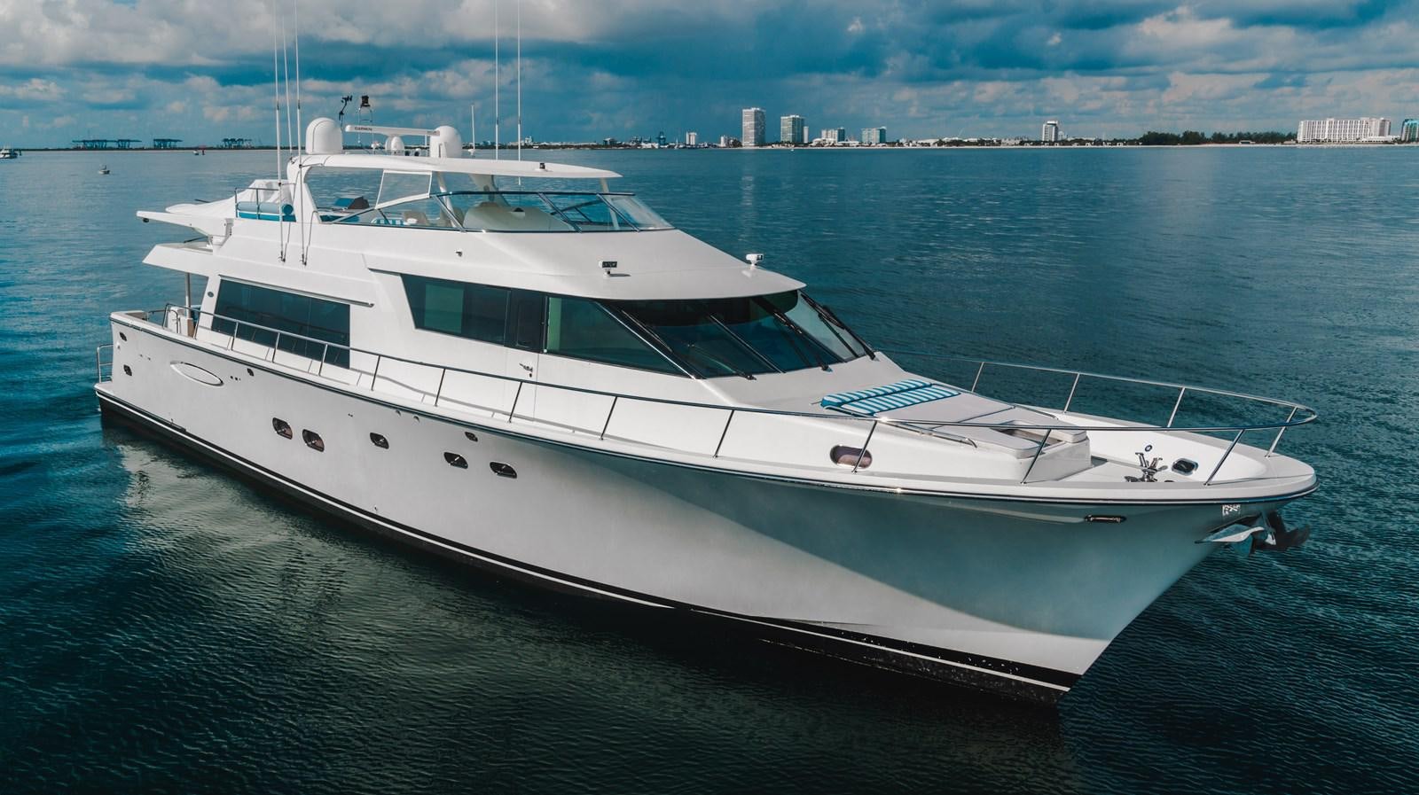 a white yacht on the water aboard NOW OR NEVER Yacht for Sale