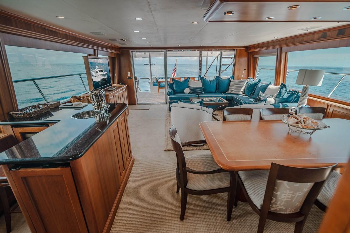 a large dining room with a large open window aboard NOW OR NEVER Yacht for Sale