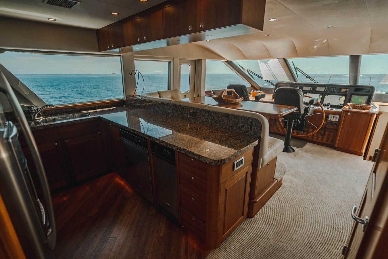 a large kitchen with a large island aboard NOW OR NEVER Yacht for Sale