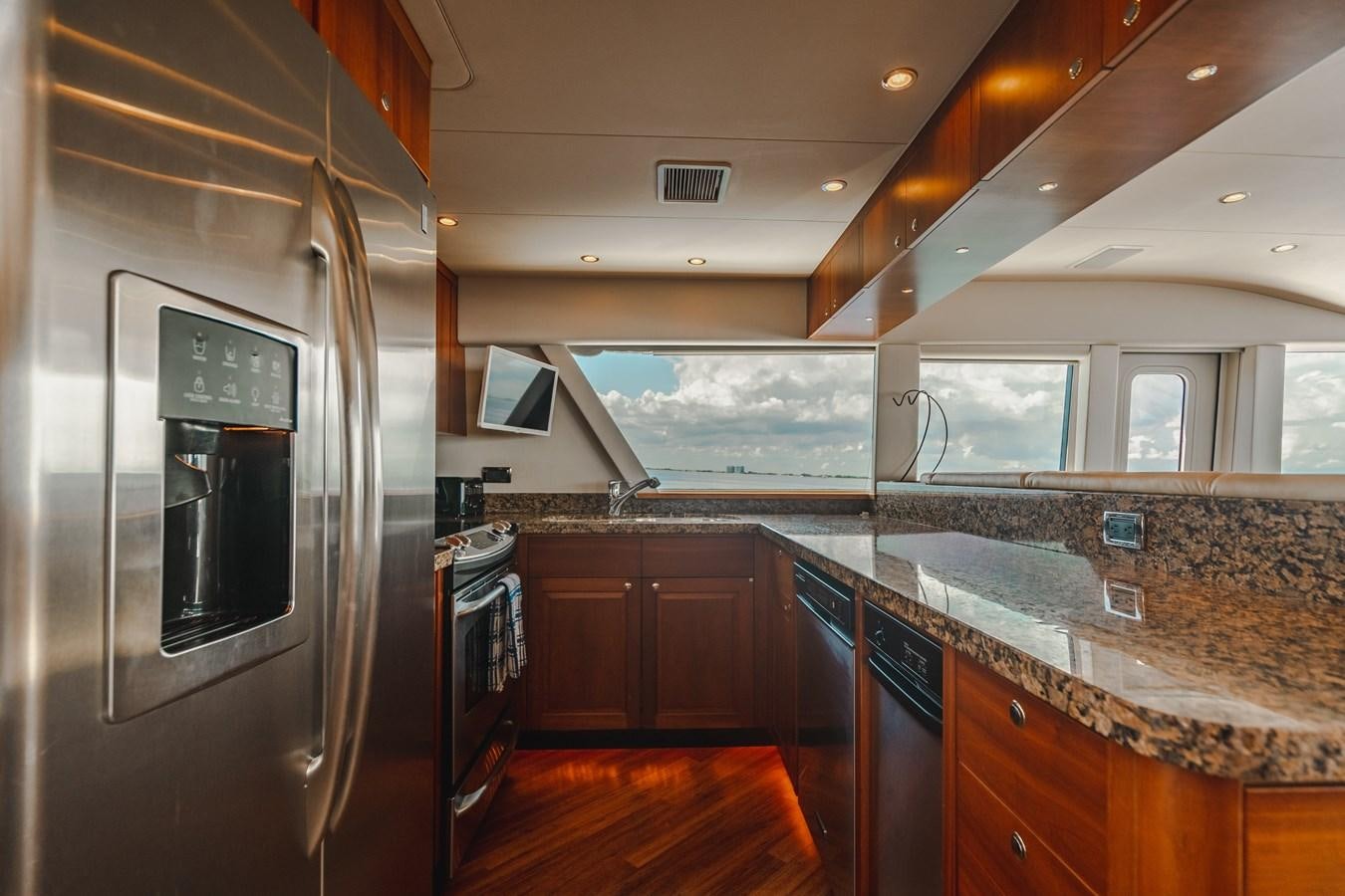 a kitchen with a large glass window aboard NOW OR NEVER Yacht for Sale
