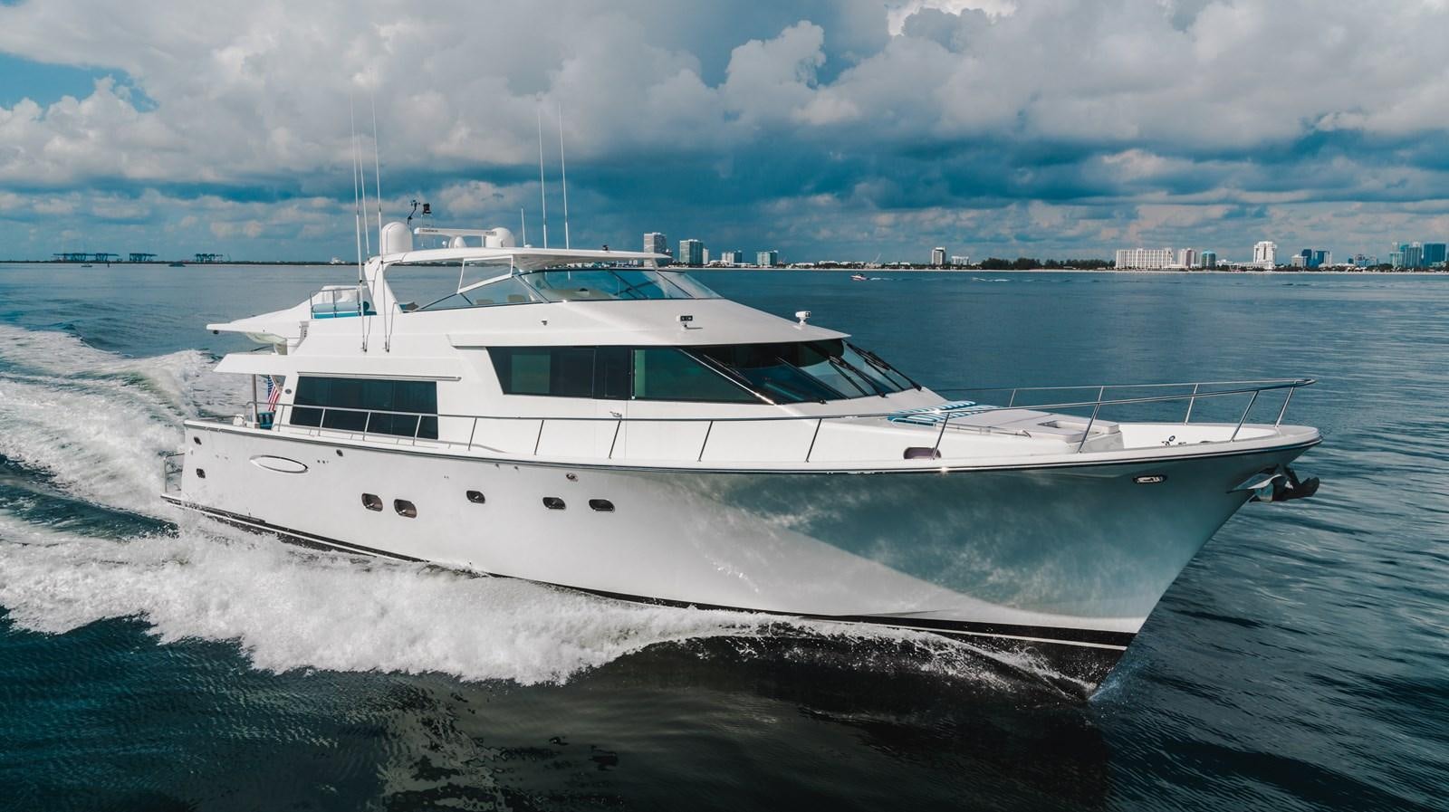 a white yacht on the water aboard NOW OR NEVER Yacht for Sale