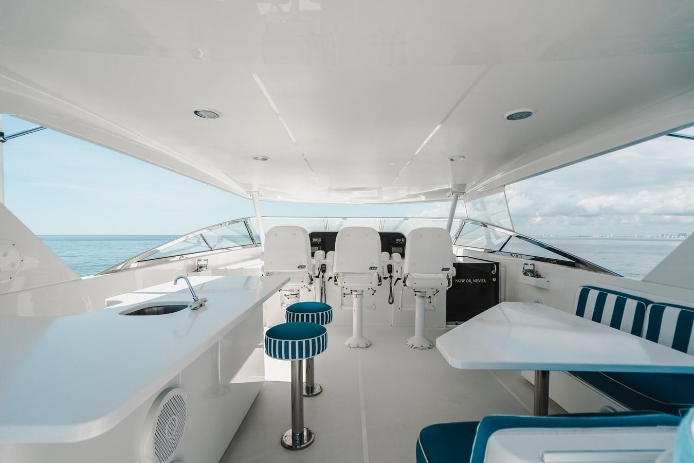 a boat with chairs on the deck aboard NOW OR NEVER Yacht for Sale