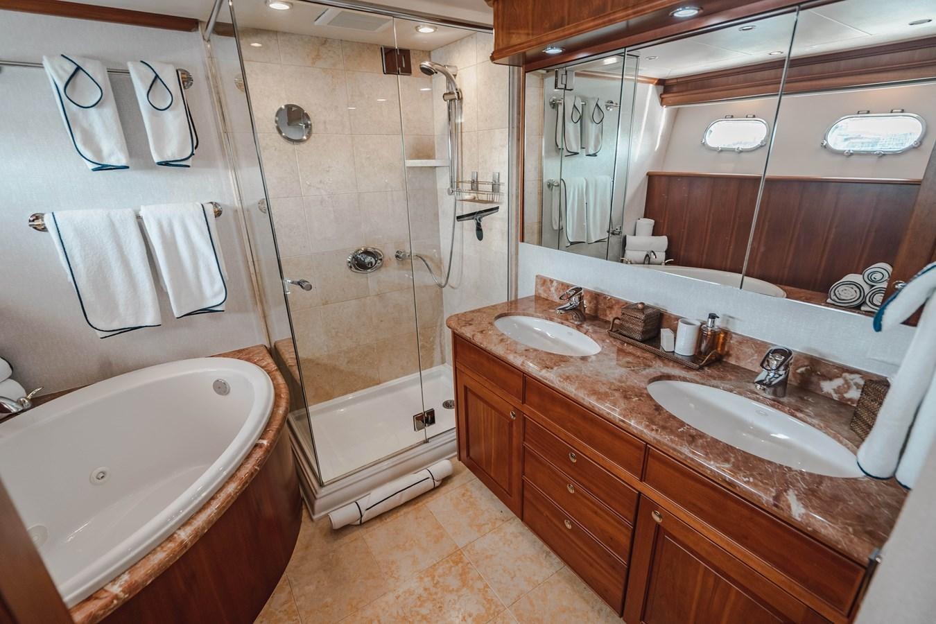 a bathroom with a large tub aboard NOW OR NEVER Yacht for Sale