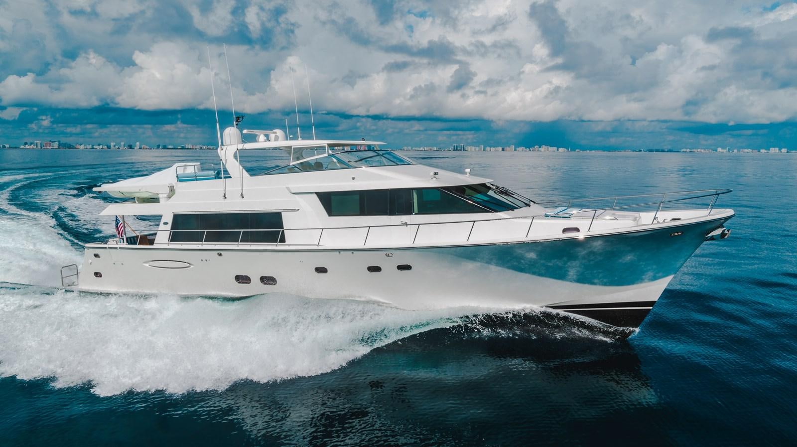 a white yacht on the water aboard NOW OR NEVER Yacht for Sale