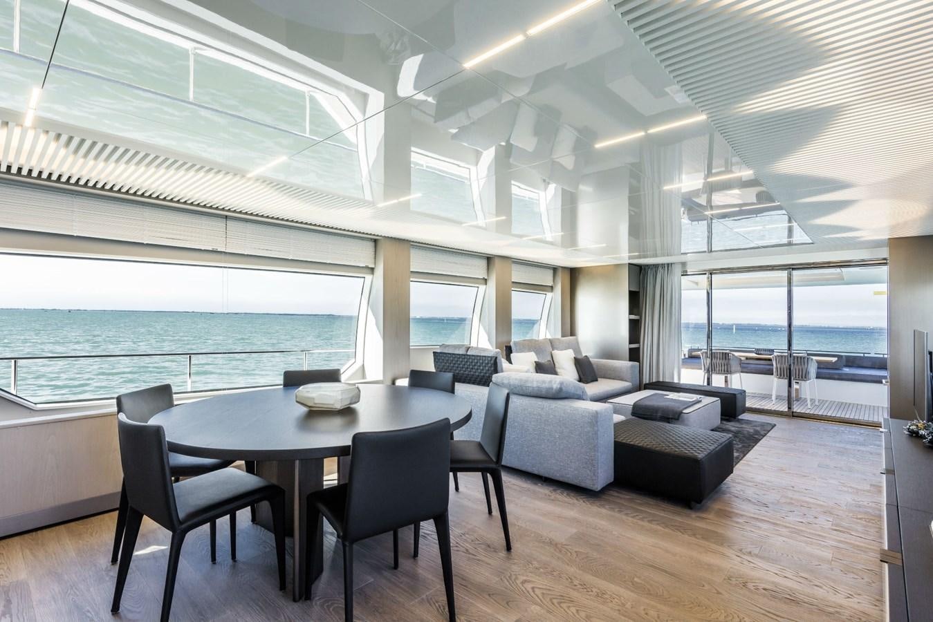 a large room with a table and chairs aboard FERRETTI YACHTS 850 HT  Yacht for Sale