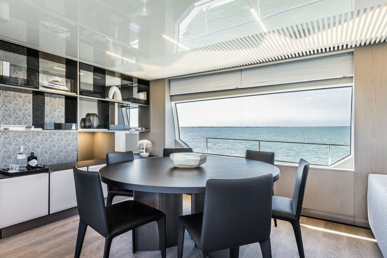 a kitchen with a table and chairs aboard FERRETTI YACHTS 850 HT  Yacht for Sale