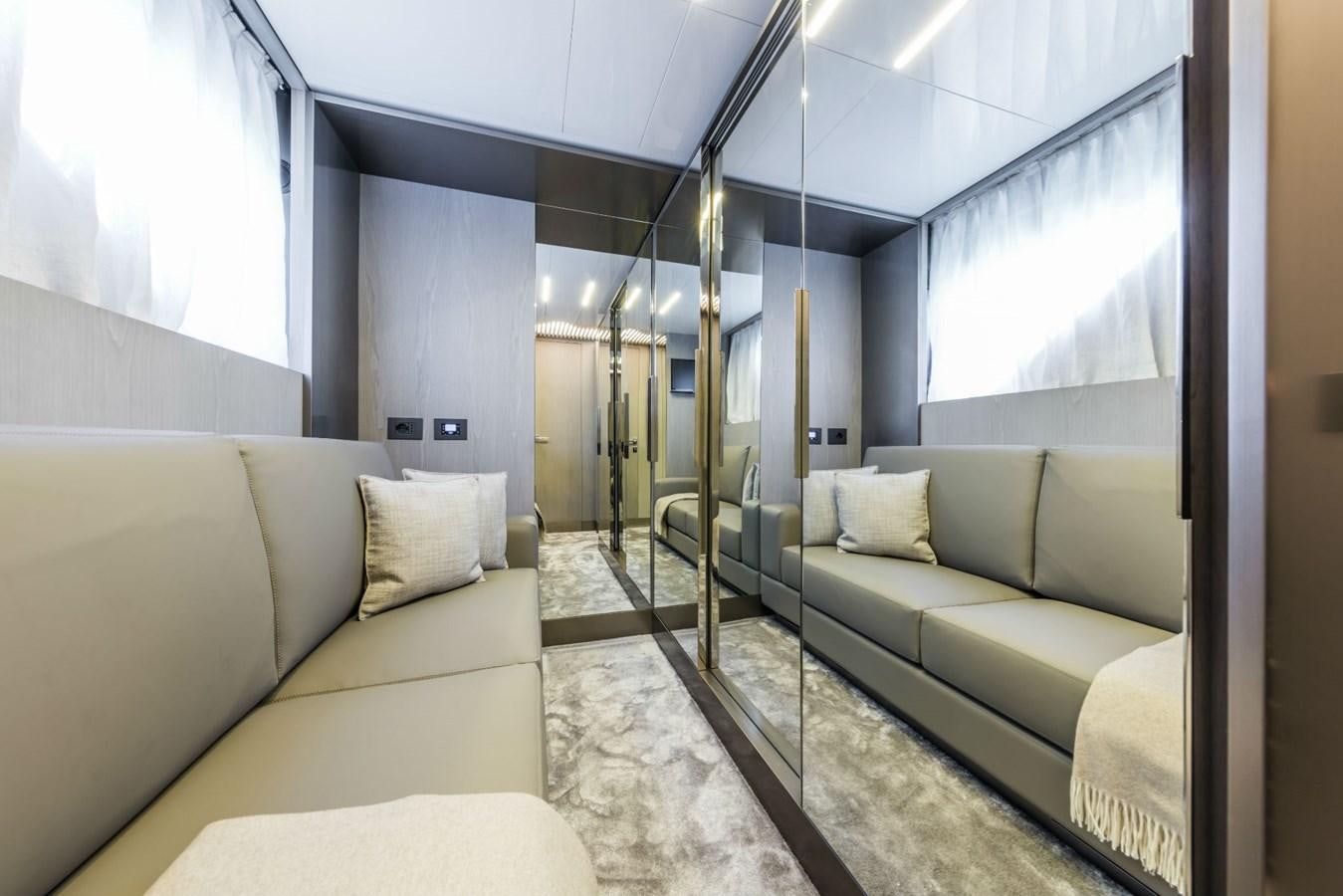 a living room with a ladder aboard FERRETTI YACHTS 850 HT  Yacht for Sale