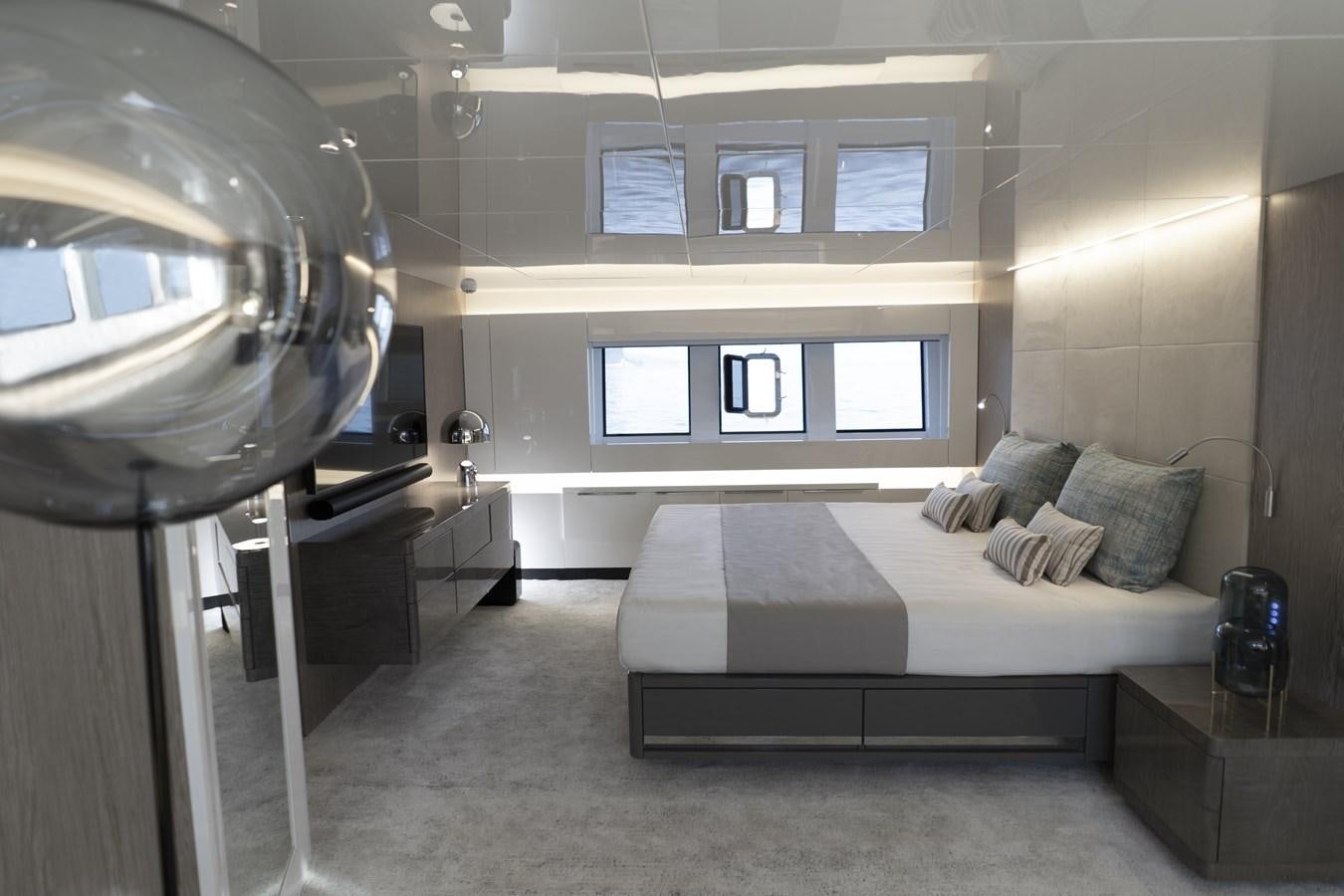 a room with a bed and a large window aboard ARCADIA A85 Yacht for Sale