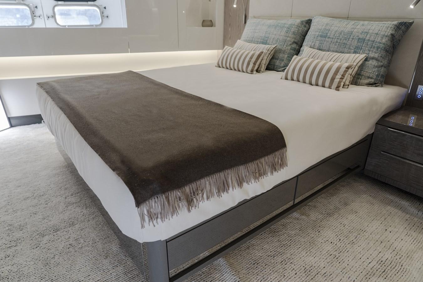 a bed with a black comforter aboard ARCADIA A85 Yacht for Sale