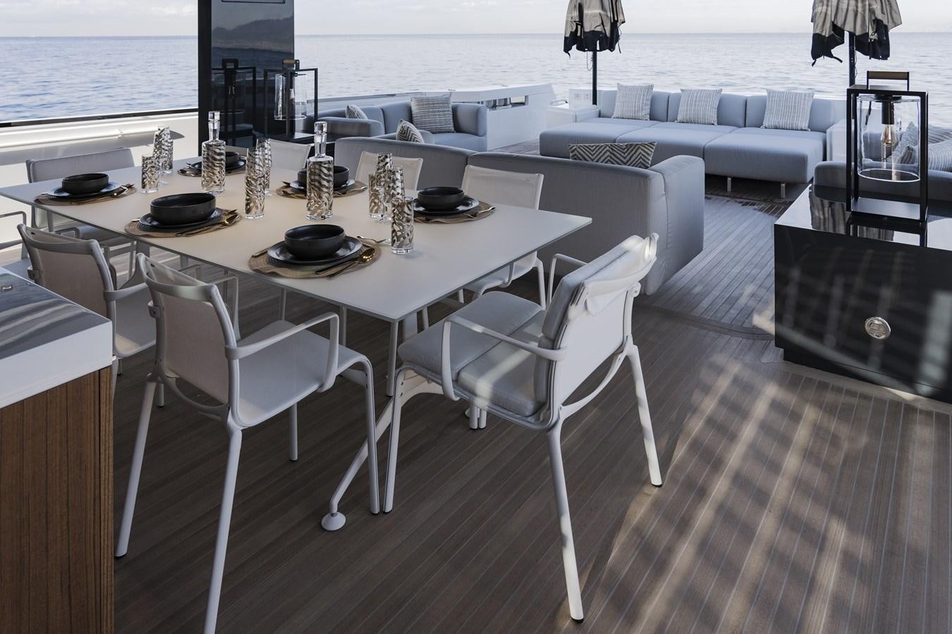 a white table with chairs around it aboard ARCADIA A85 Yacht for Sale