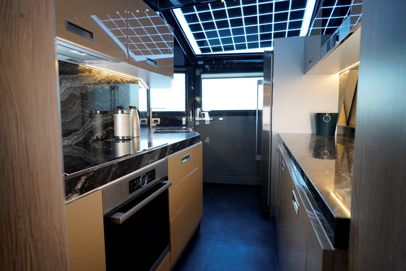 a kitchen with stainless steel appliances aboard ARCADIA A85 Yacht for Sale