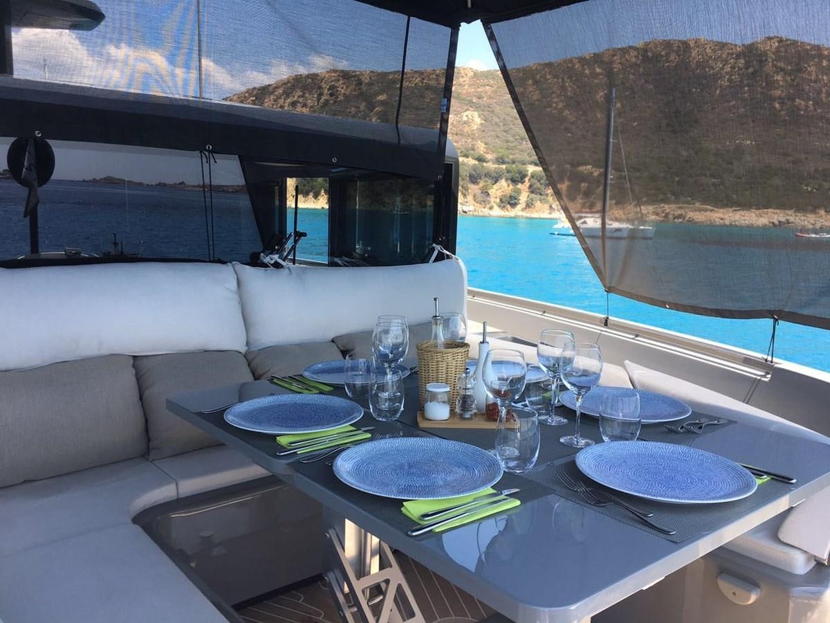 a table with plates and glasses on it aboard MARCELLO Yacht for Sale