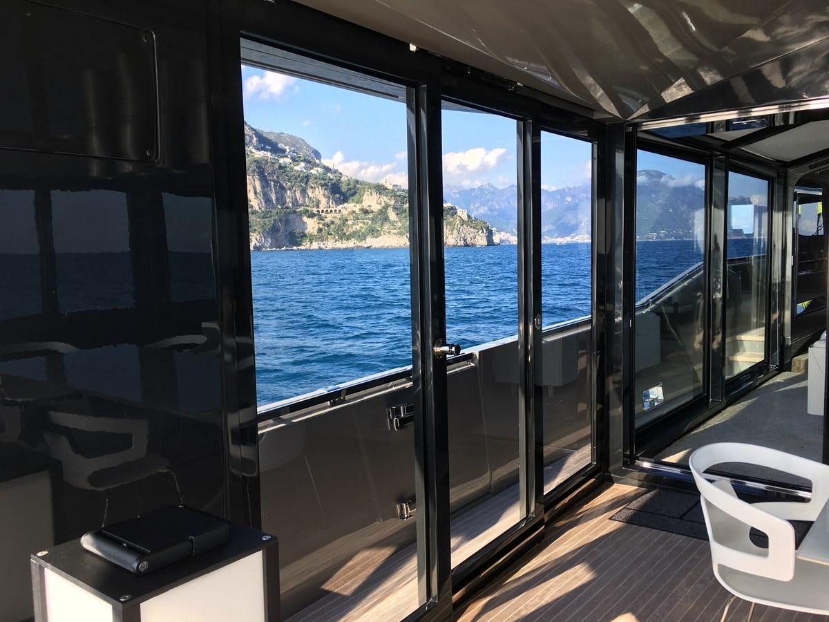a room with a view of the ocean and the land below aboard MARCELLO Yacht for Sale