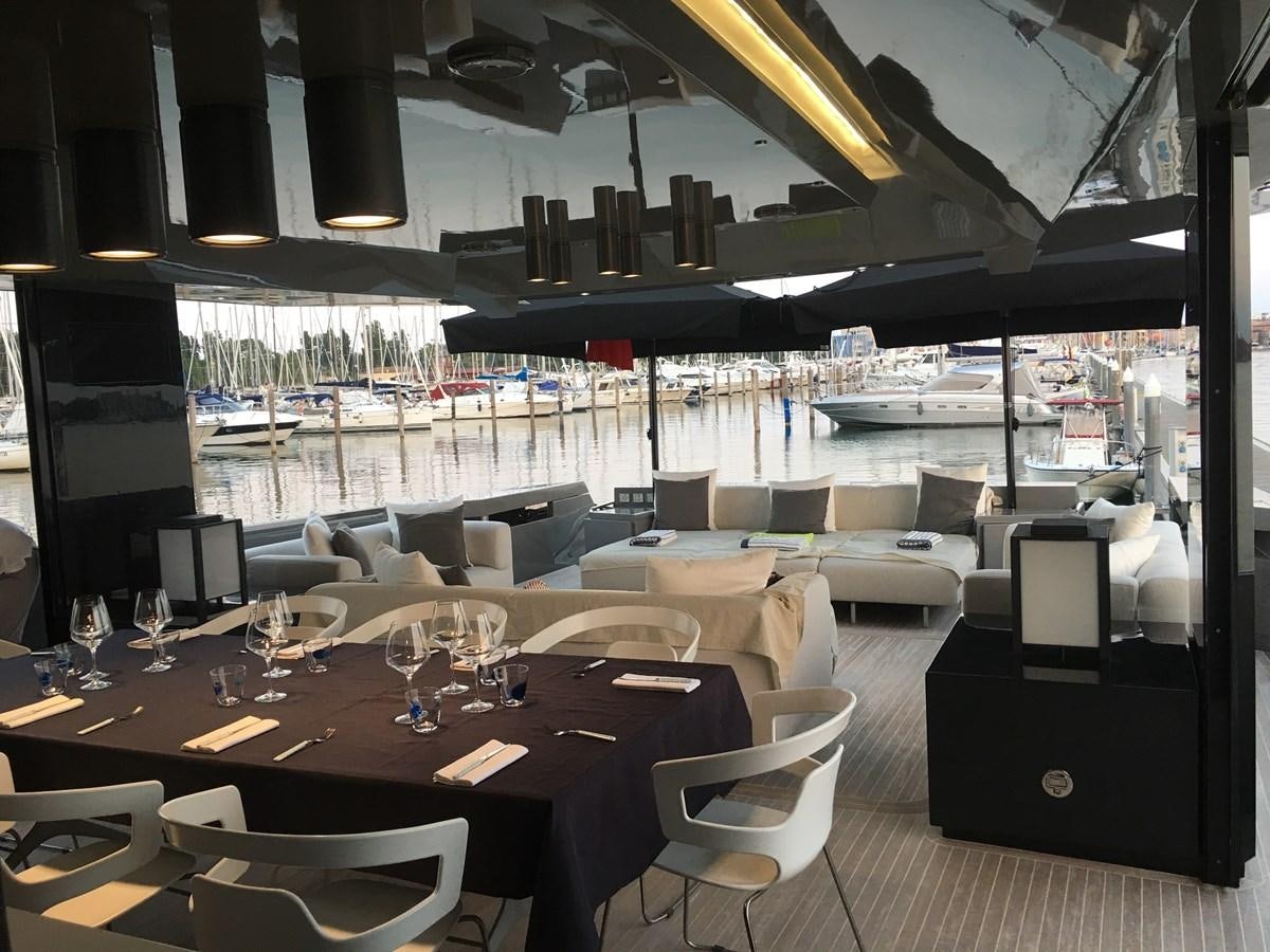 a room with a table chairs and a large window aboard MARCELLO Yacht for Sale