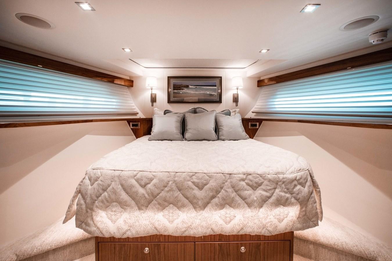 a bedroom with a bed and a window aboard NEW VIKING 82 COCKPIT MOTOR YACHT Yacht for Sale