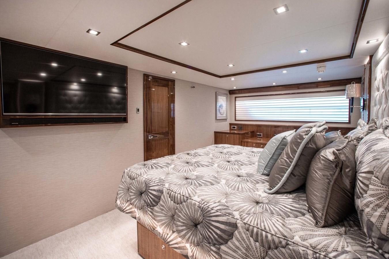 a bedroom with a bed and a television aboard NEW VIKING 82 COCKPIT MOTOR YACHT Yacht for Sale