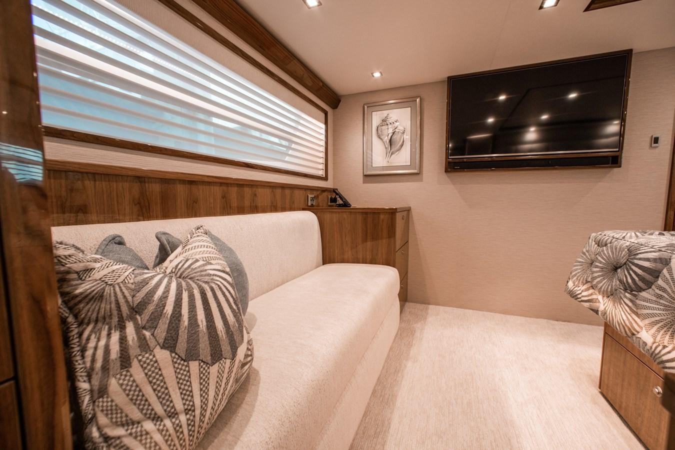 a living room with a couch and a television aboard NEW VIKING 82 COCKPIT MOTOR YACHT Yacht for Sale